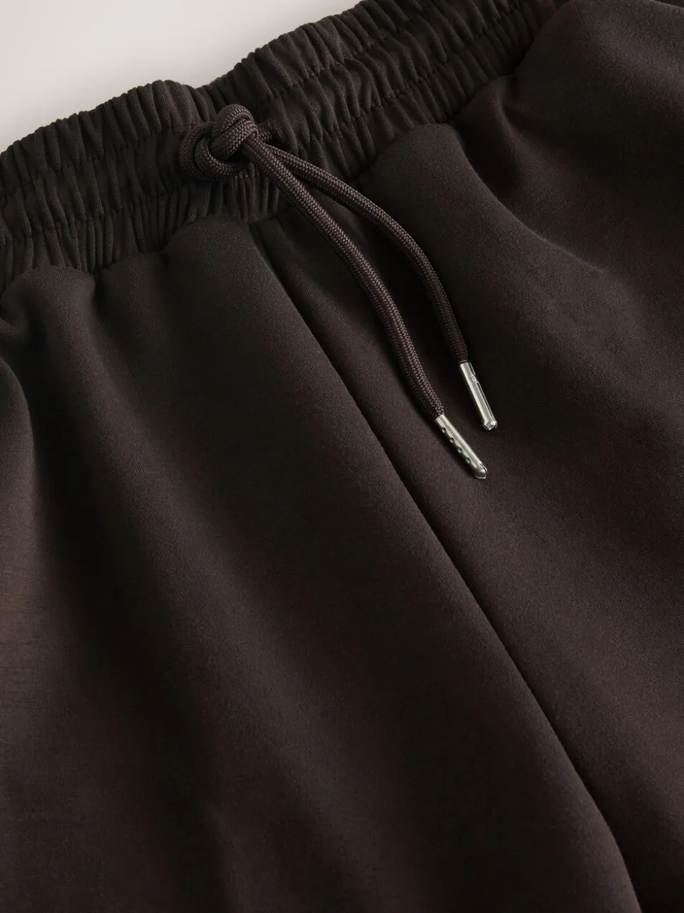Chocoladebruin - Slinky trainingsbroek met wijde pijpen en zijstrepen