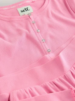 Felroze - self. Geribbelde pyjama met knopen