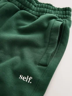 Groen - Self. joggingbroek met boorden