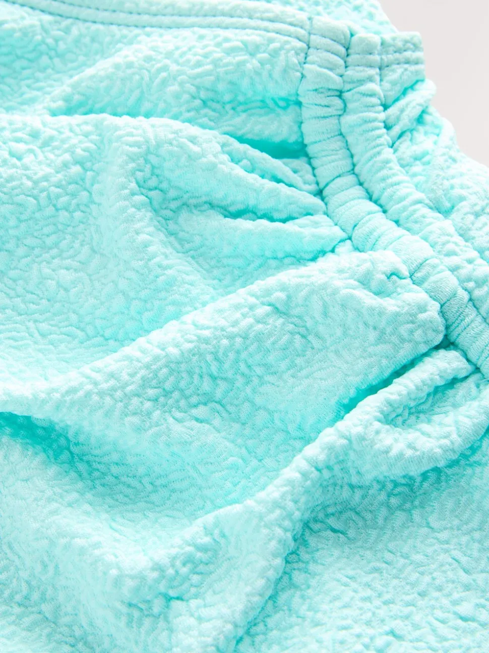 Mintgroen, textuur - Badpak met vormgevende zijrimpeling en buikcorrectie