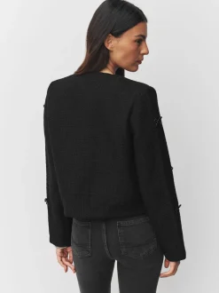 Zwart - Bouclé jackje met kralenstrik