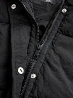 Zwart - Regenbestendige bodywarmer met capuchon en gebreide kraag