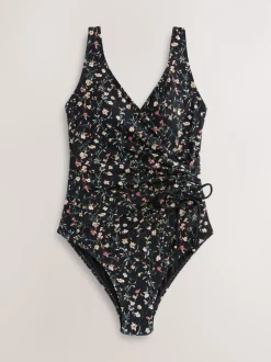 Zwart met broderie en fijne print - Badpak met vormgevende zijrimpeling en buikcorrectie
