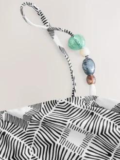 Zwart/crème met aztekenprint - Asymmetrische bikinitop met kralen