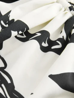 Zwart/Crème Palm - Badpak met vormgevende zijrimpeling en buikcorrectie
