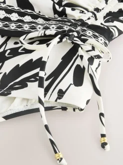 Zwart/Crème Palm - Badpak met vormgevende zijrimpeling en buikcorrectie