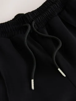 Zwart/neutraal - Slinky trainingsbroek met wijde pijpen en zijstrepen